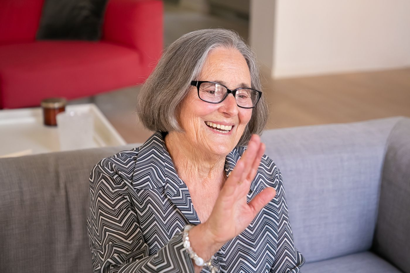 A grandmother waving during a video check-in